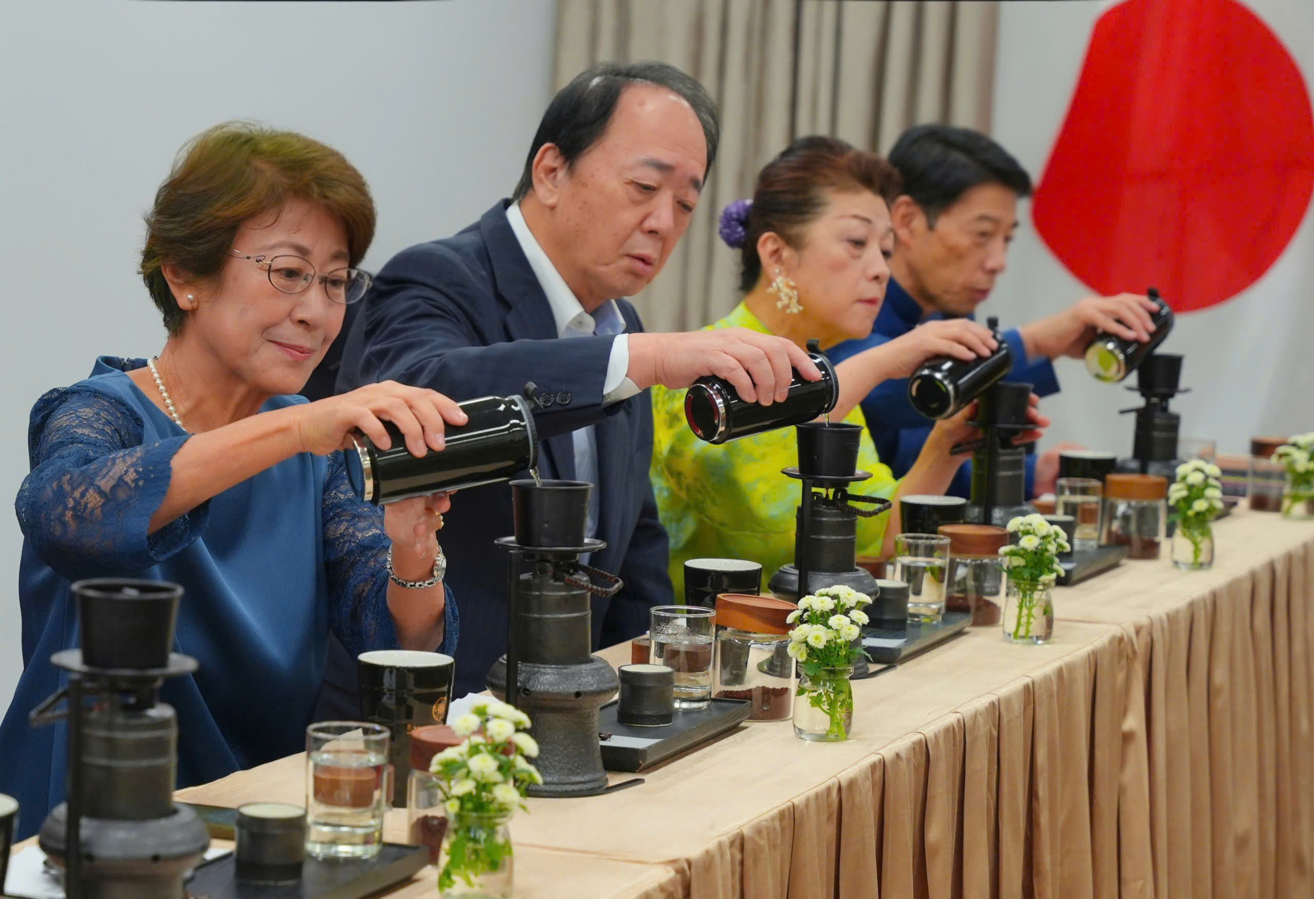 Thống đốc tỉnh Fukuoka và Phu nhân (bên phải), Chủ tịch Hội đồng tỉnh Kagoshima và Phu nhân (bên trái) ấn tượng với trải nghiệm Thiền Cà Phê trong chương trình “Viet Nam Day 2026”.